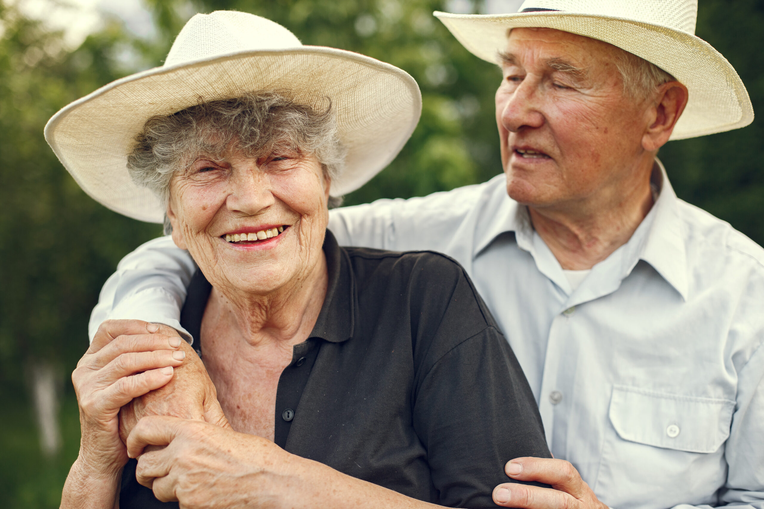 Beautiful old couple spend time in a summer garden
