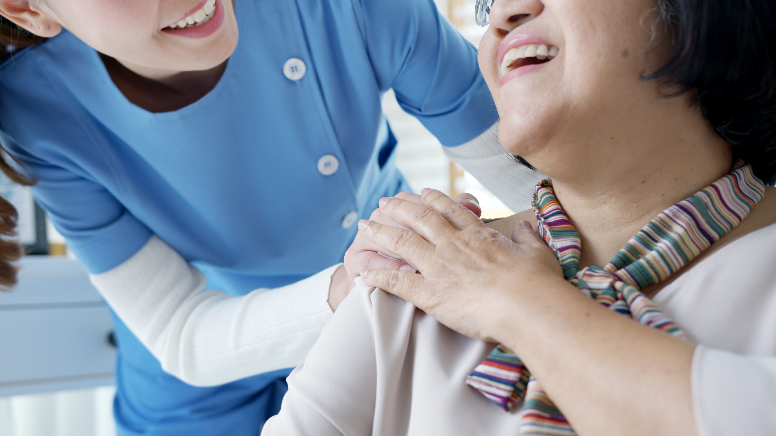 Young asian woman or nurse home care hand on senior grandmother